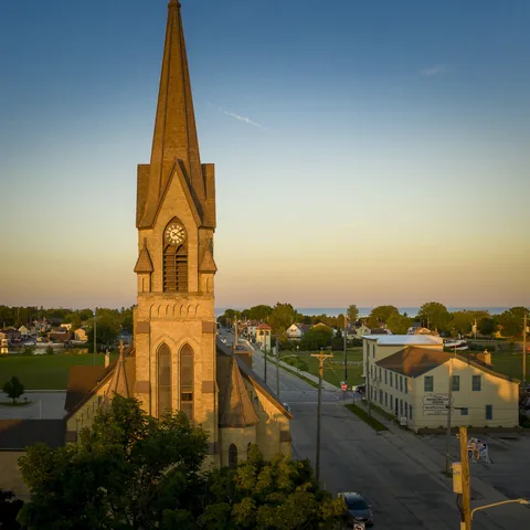 Church clock tower lit by the warm evening sun