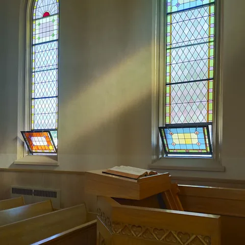 Sunlight through stained glass falling across the pulpit